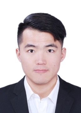 A person wearing a suit and tie smiling at the cameraDescription automatically generated